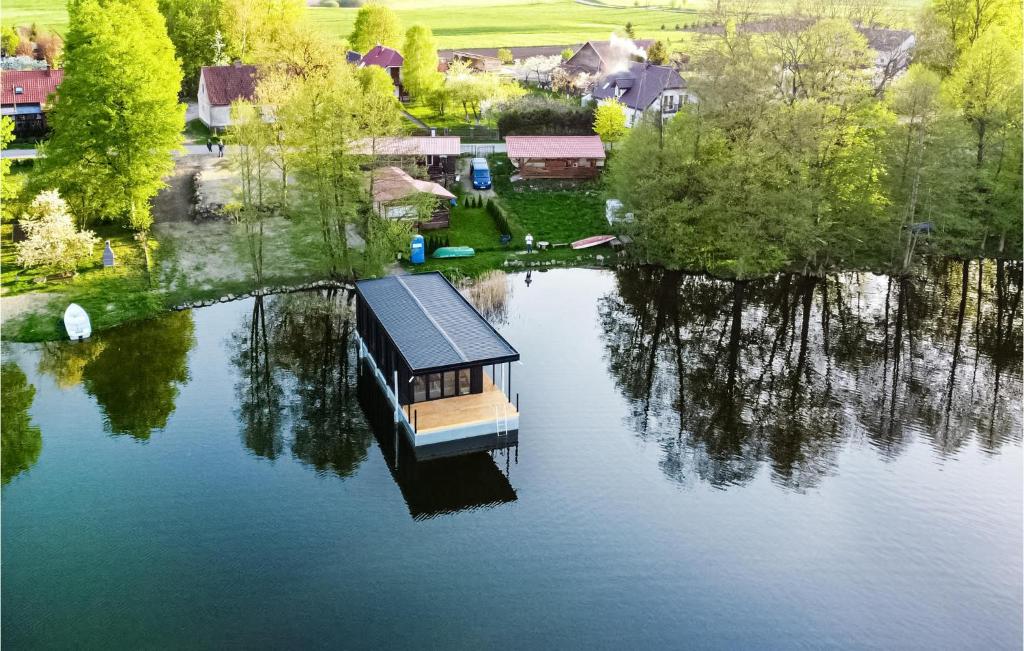 an aerial view of a house on a lake at Pet Friendly Ship In Kruklanki With Lake View in Kruklanki