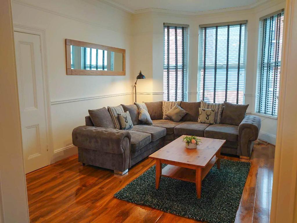 a living room with a couch and a coffee table at Modern Luxury 3 bed house in Plymouth