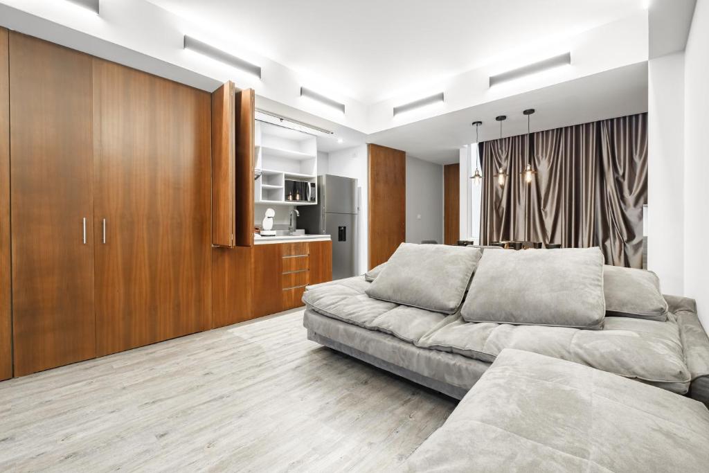 a bedroom with a large bed and wooden cabinets at Urban Getaway, Trendy Polanco, Home Office in Mexico City