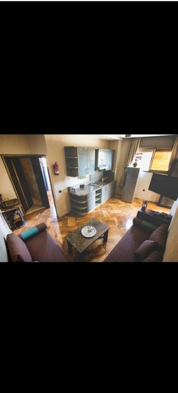 a living room with two couches and a table at Auberge guest house1 in Imsouane