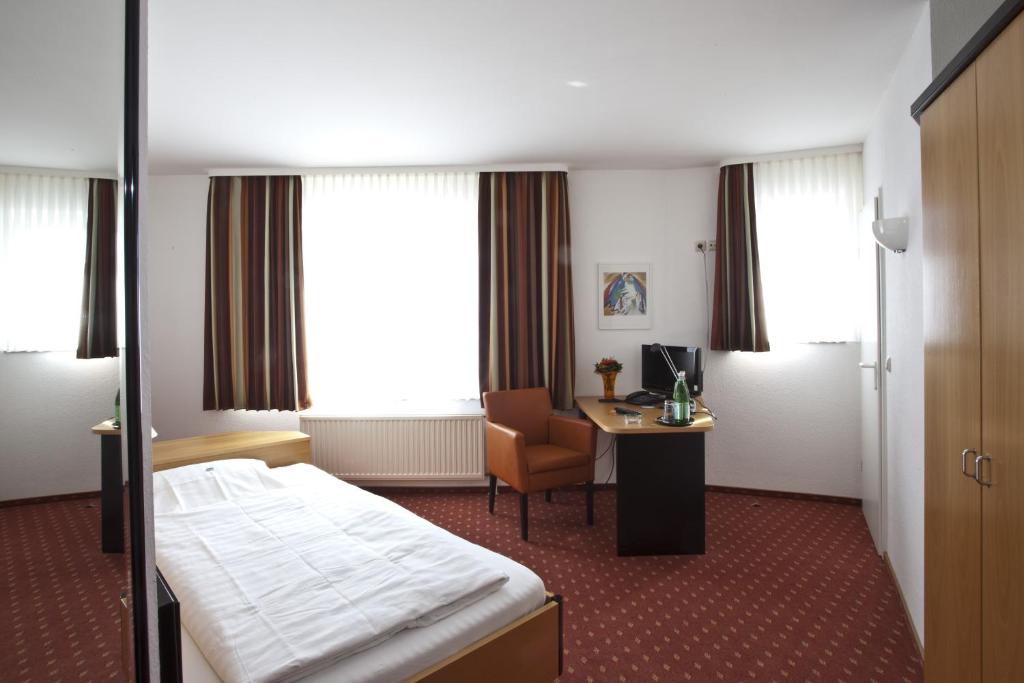 Postel nebo postele na pokoji v ubytování Hotel Am Braunen Hirsch