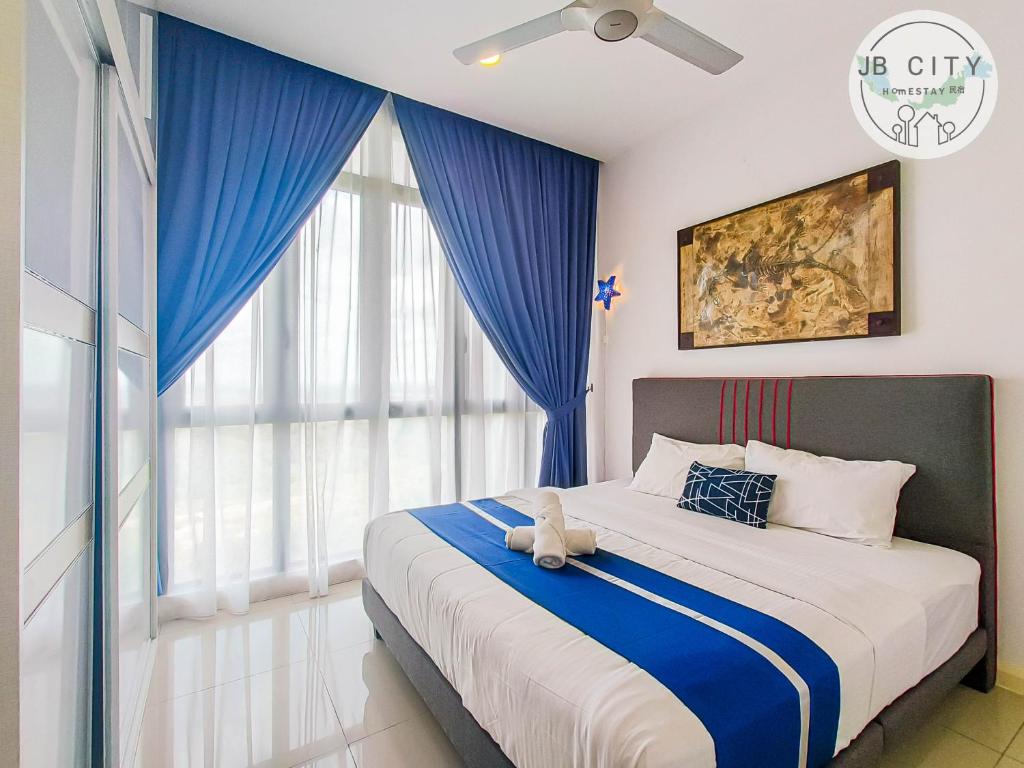 a bedroom with a bed with a teddy bear on it at D'Pristine Suites by JBcity Home in Nusajaya
