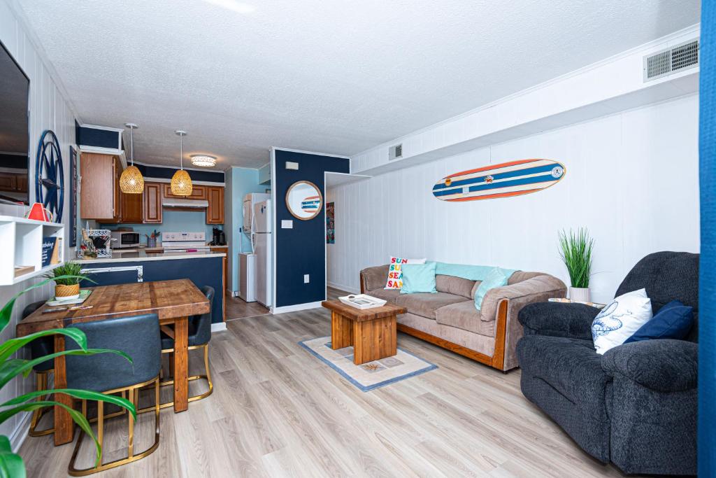 a living room with a couch and a table at Fenwick Woods OC in Ocean City