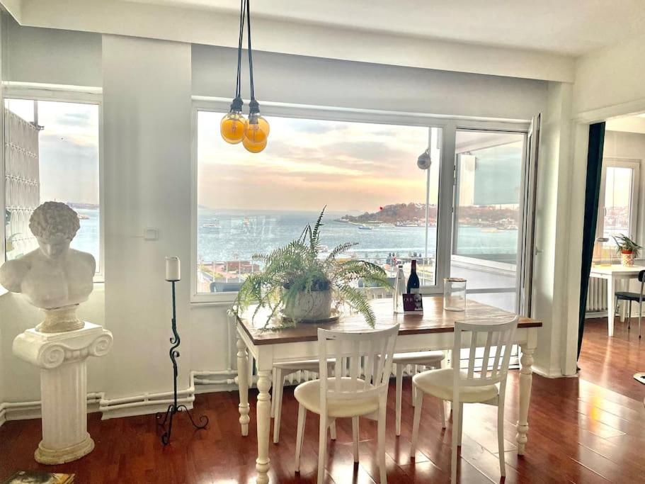 a dining room with a table and a view of the ocean at House of Design *Hagia Sophia View* in Istanbul