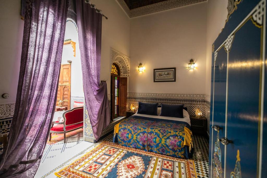 Postel nebo postele na pokoji v ubytování Riad Arabella