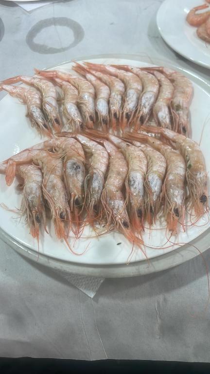 une plaque avec une bande de crevettes sur une table dans l'établissement Maison de plage familles, à Saïdia