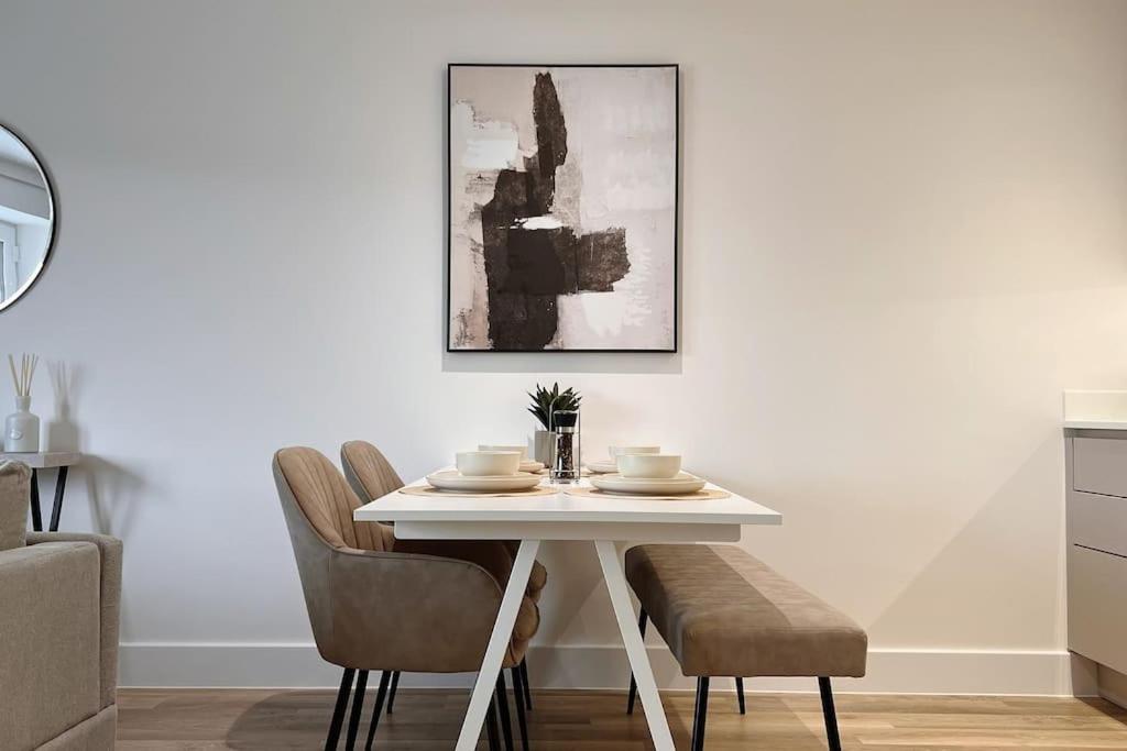 a white dining room table with chairs and a picture at No29, Luxury Apartment near Bicester Village in Bicester