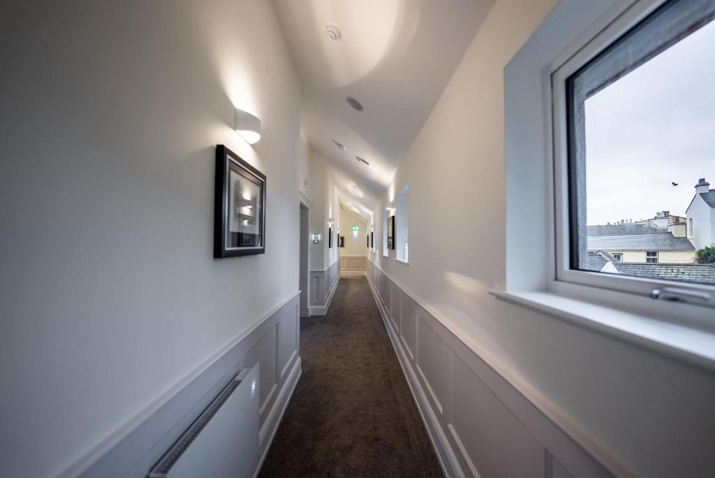 a hallway with a window in a house at Shore Hotel Laxey in Laxey