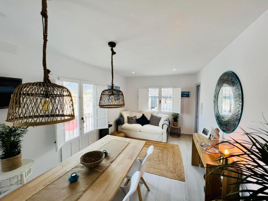 a living room with a table and a couch at Casa MiraMar in Salobreña