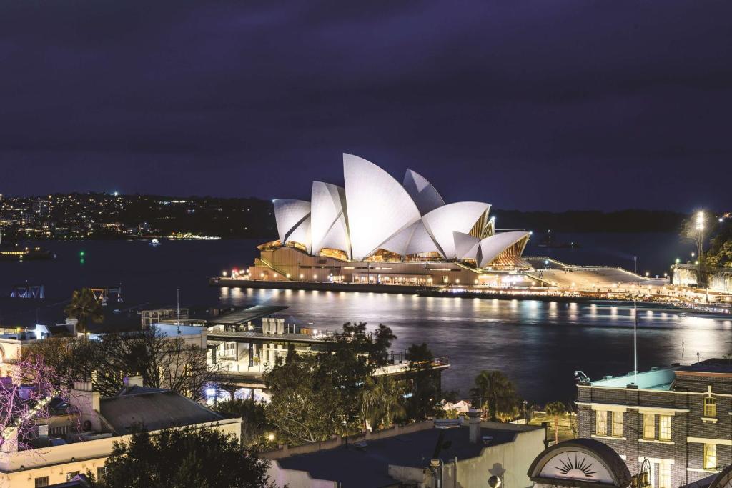 una vista de la ópera Sydney por la noche en Rendezvous Hotel Sydney The Rocks en Sídney