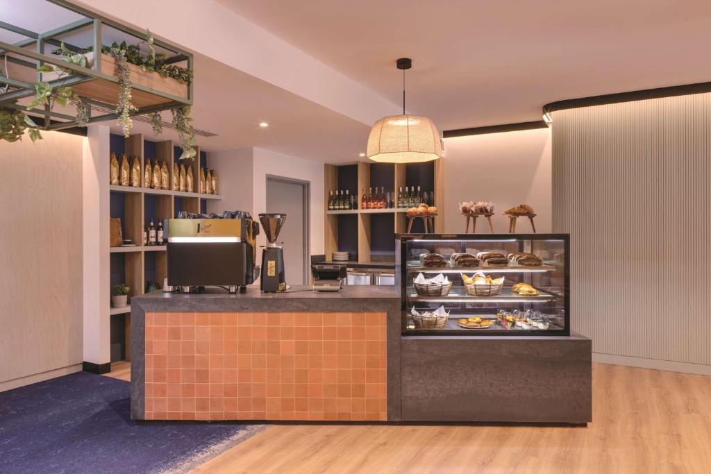 a bakery with a counter with pastries at Travelodge Hotel Hurstville Sydney in Sydney