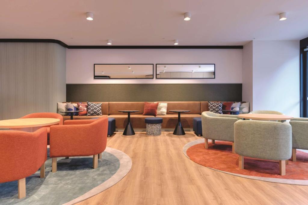 a waiting room with tables and chairs at Travelodge Hotel Hurstville Sydney in Sydney