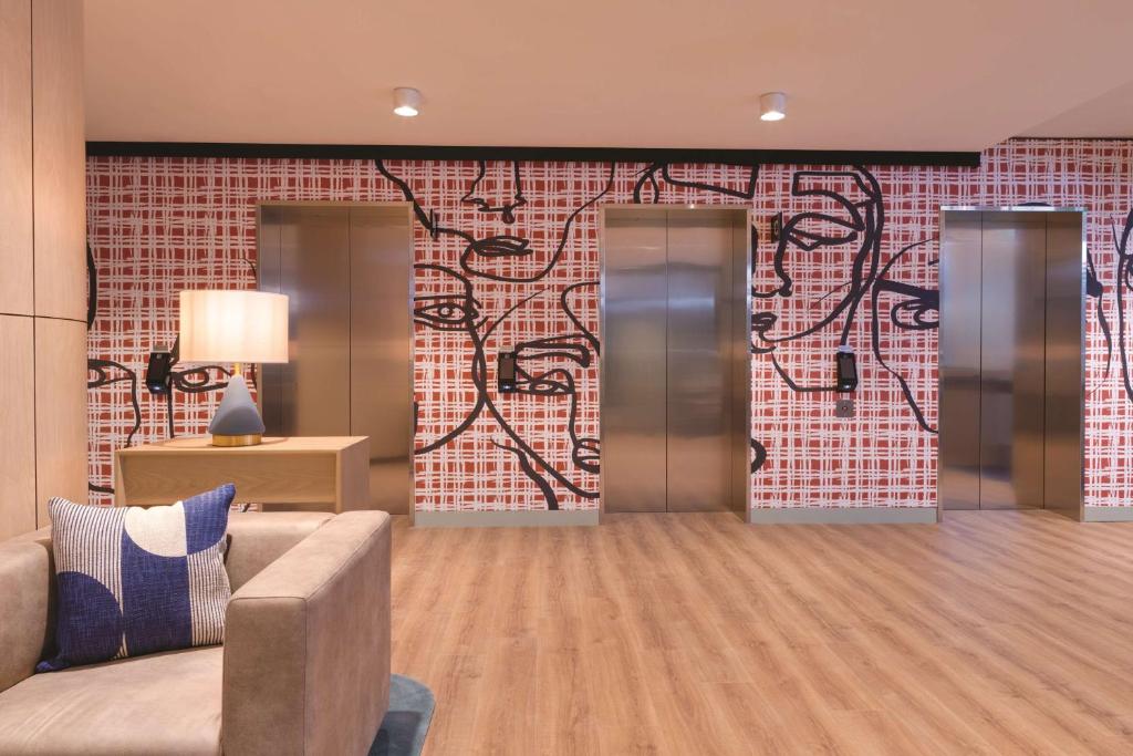 a lobby with a couch and a brick wall at Travelodge Hotel Hurstville Sydney in Sydney