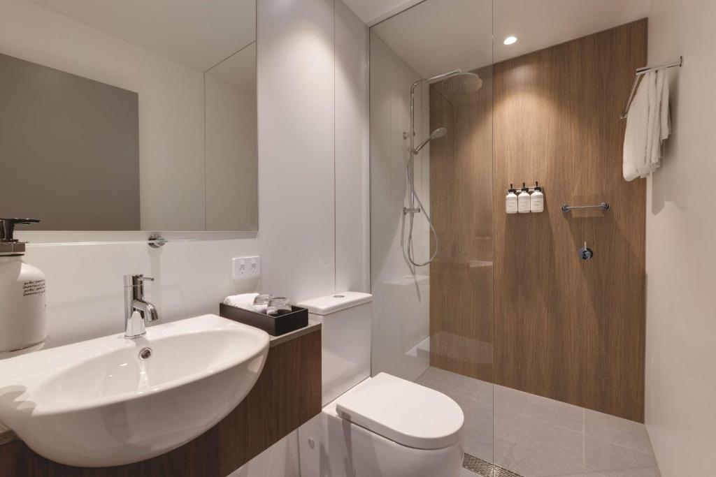 a bathroom with a sink and a toilet and a shower at Travelodge Hotel Hurstville Sydney in Sydney