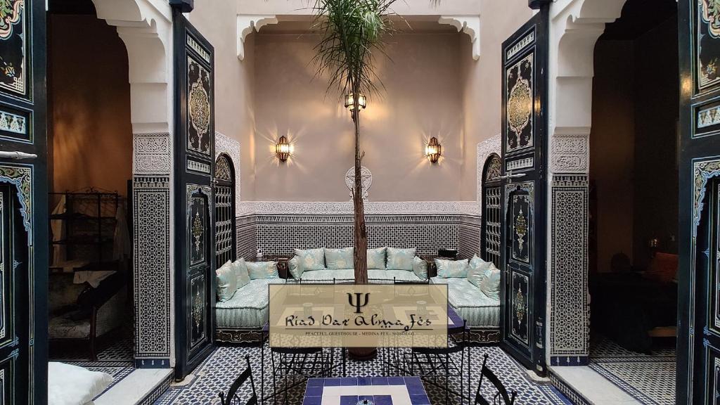 a room with a table with a palm tree in it at Riad Dar Alma Fes in Fès