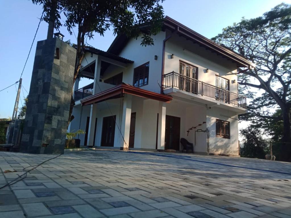 a view of the house from the driveway at White House Family Stay in Maspota