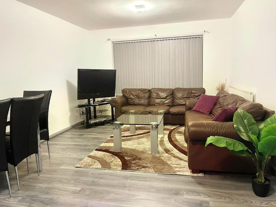 a living room with a couch and a table at Lovely 3 Bed Apartment Near QE Hospital Harborne Birmingham New in Birmingham