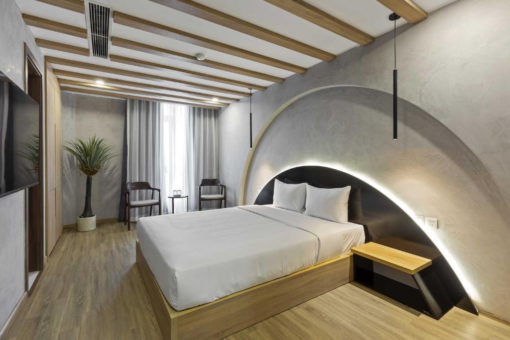 Postel nebo postele na pokoji v ubytování Jacayl Hotel TCG