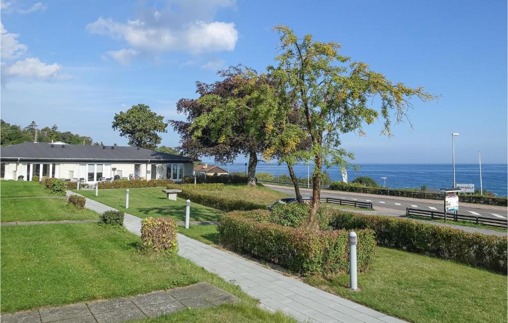 a house on the side of a road near the ocean at Awesome Apartment In Allinge in Allinge