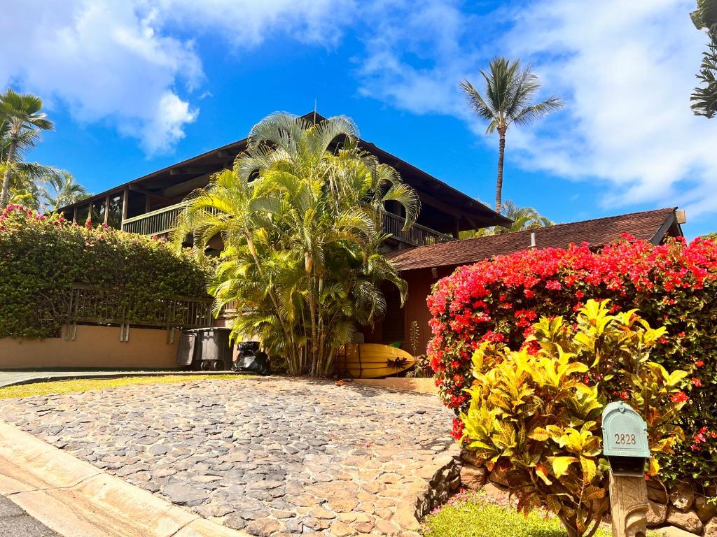 a house with flowers in front of it at Maui What a Wonderful World Bed & Breakfast in Wailea