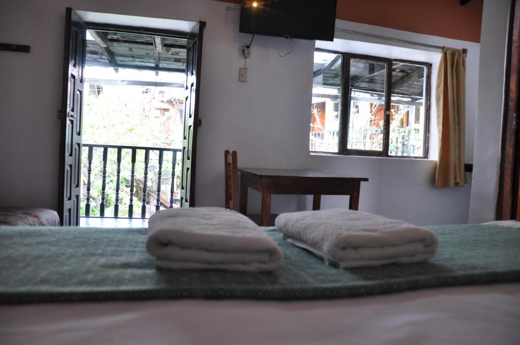 Postel nebo postele na pokoji v ubytování Las Orquideas Ollantaytambo
