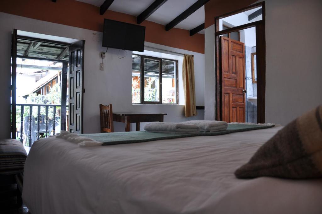 Postel nebo postele na pokoji v ubytování Las Orquideas Ollantaytambo