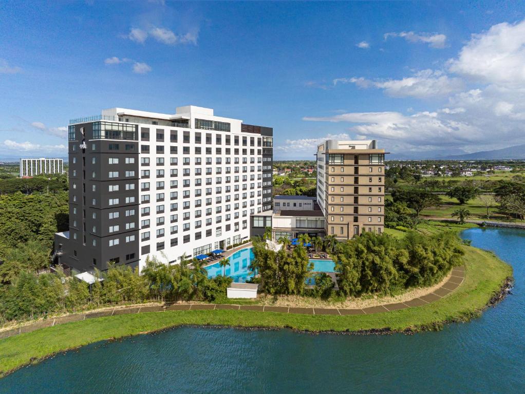 an aerial view of two tall buildings next to a body of water at Seda Nuvali in Santa Rosa