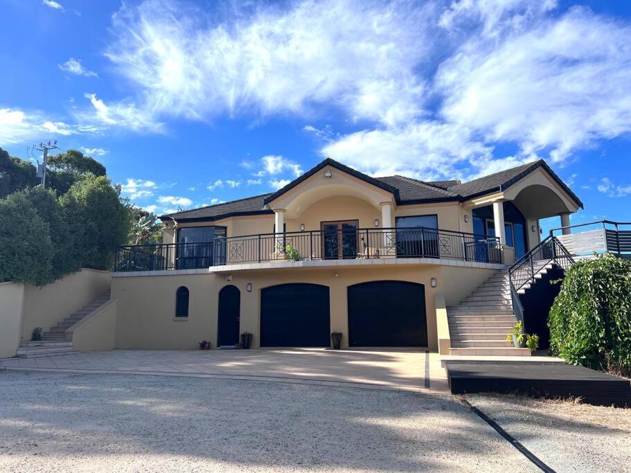 a large house with a balcony on top of it at Zentala in Port Lincoln