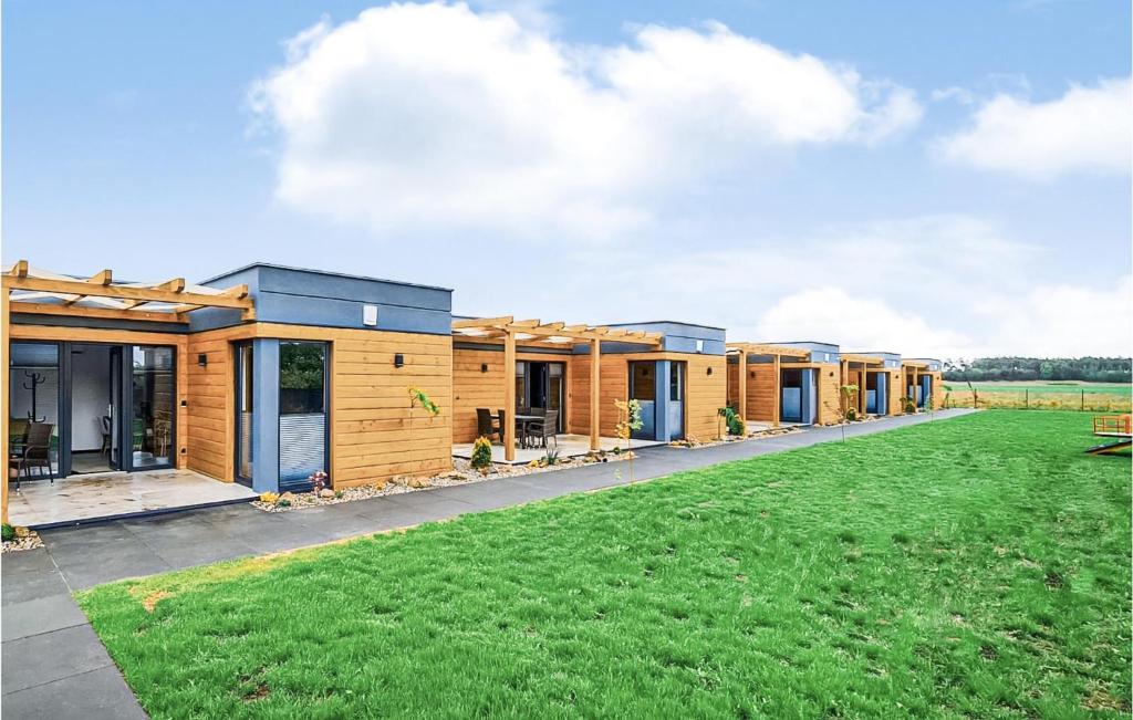 a row of modular homes on a lawn at Stunning Home In Nowecin With Kitchen in Nowecin