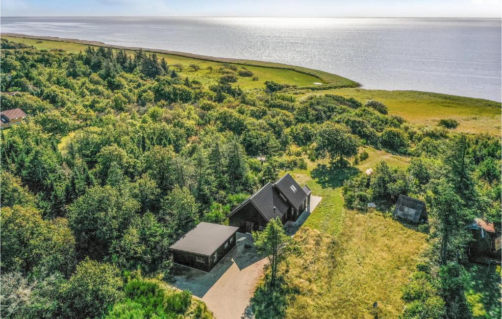 an aerial view of a house on a hill next to the water at Stunning Home In Skjern With Kitchen in Skjern