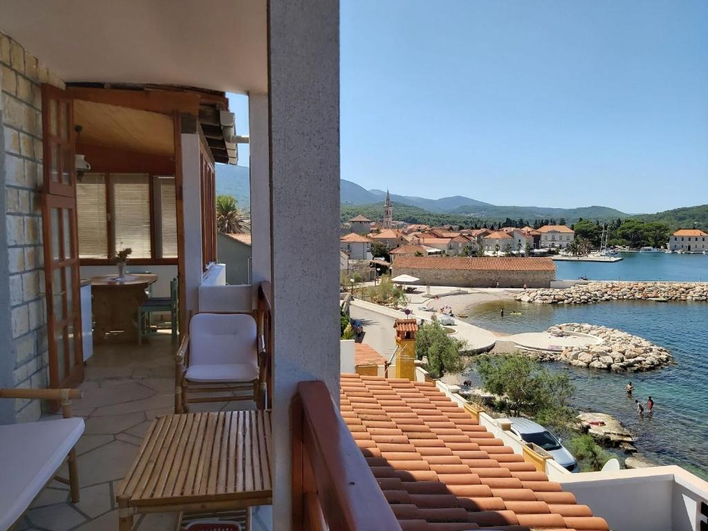 a balcony with a view of a body of water at Apartment Next to the sea in Jelsa