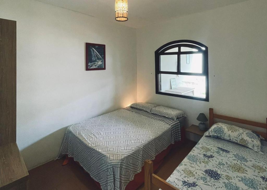 a room with two beds and a window at VILLA PRAIA GRANDE in Matinhos