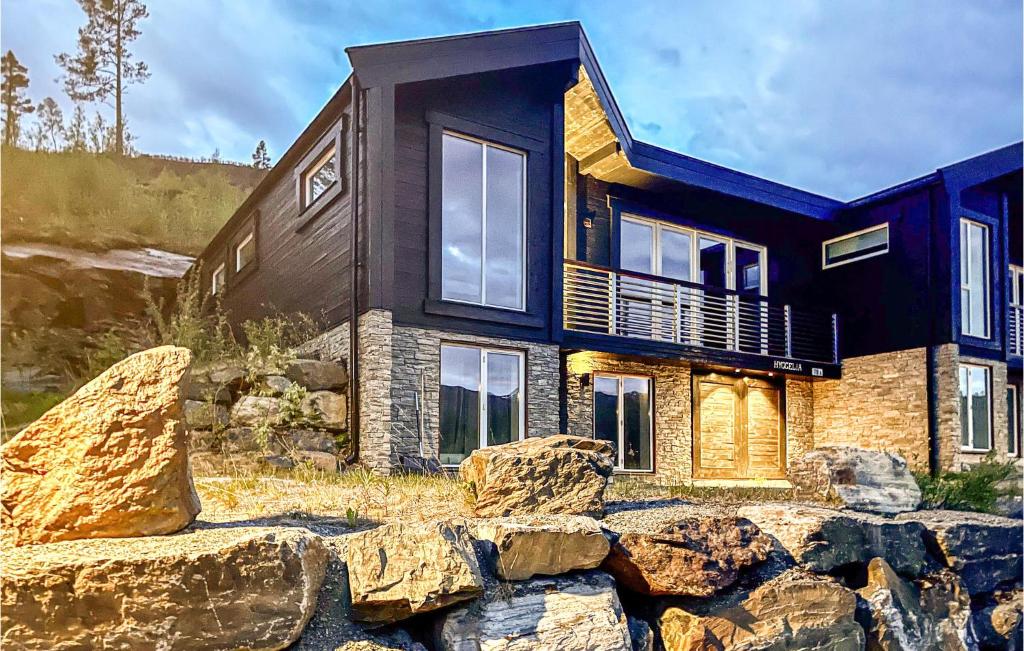 a house with rocks in front of it at 5 Bedroom Cozy Home In Hemsedal in Hemsedal