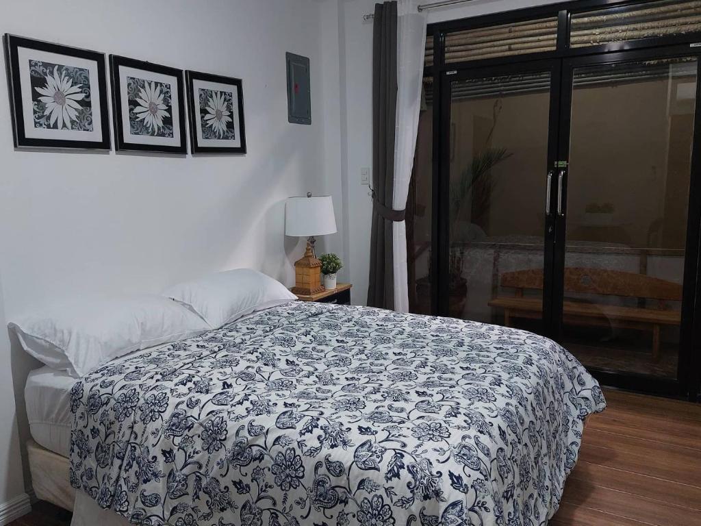 1 dormitorio con 1 cama con manta blanca y negra en Regal425 Condotel, en Ángeles