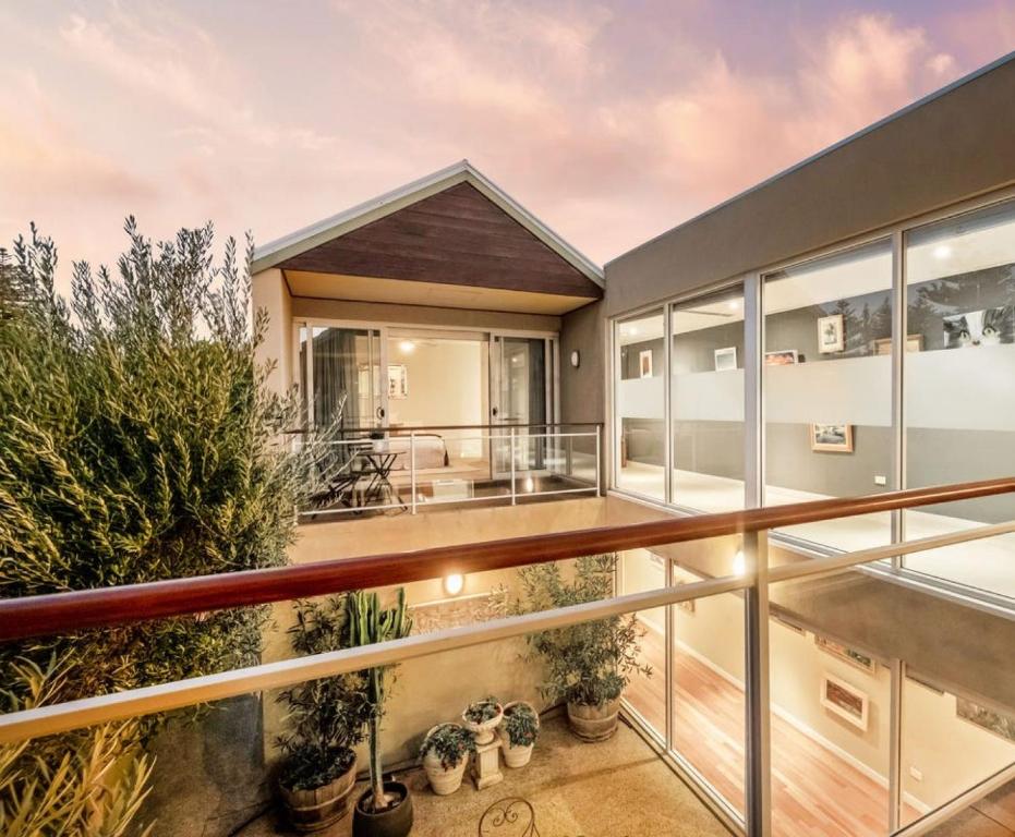 an open balcony of a house with plants at Cottesloe Beach Haven in Perth
