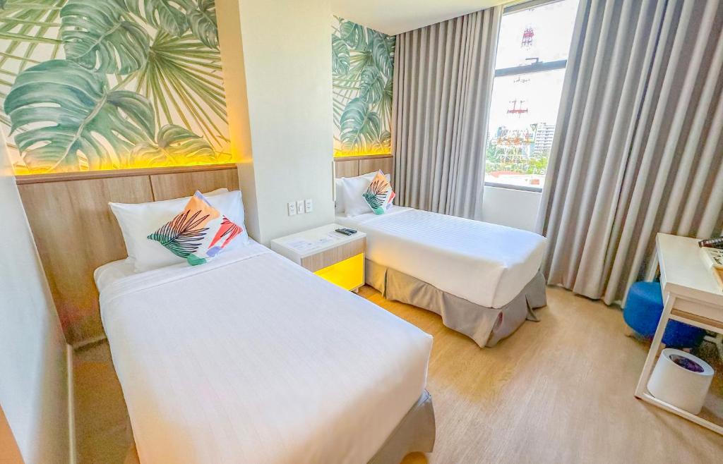 Un pat sau paturi într-o cameră la Harolds Evotel Quezon City