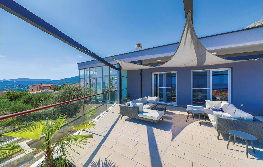 a patio with couches and chairs on a house at Amazing Home In Kastel Stari With Kitchen in Kastel Novi