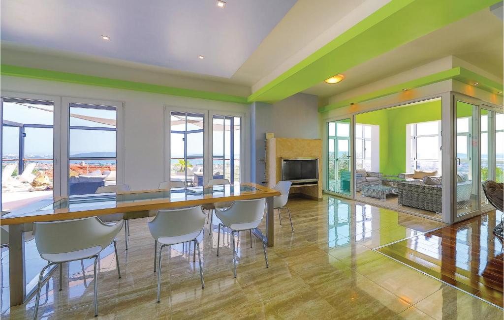 a dining room with a long table and chairs at Amazing Home In Kastel Stari With Kitchen in Kastel Novi