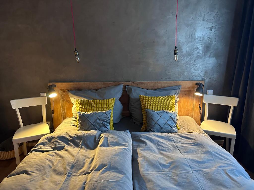 een slaapkamer met een bed met 2 stoelen bij Designapartment 2.0 in Lutherstadt Wittenberg