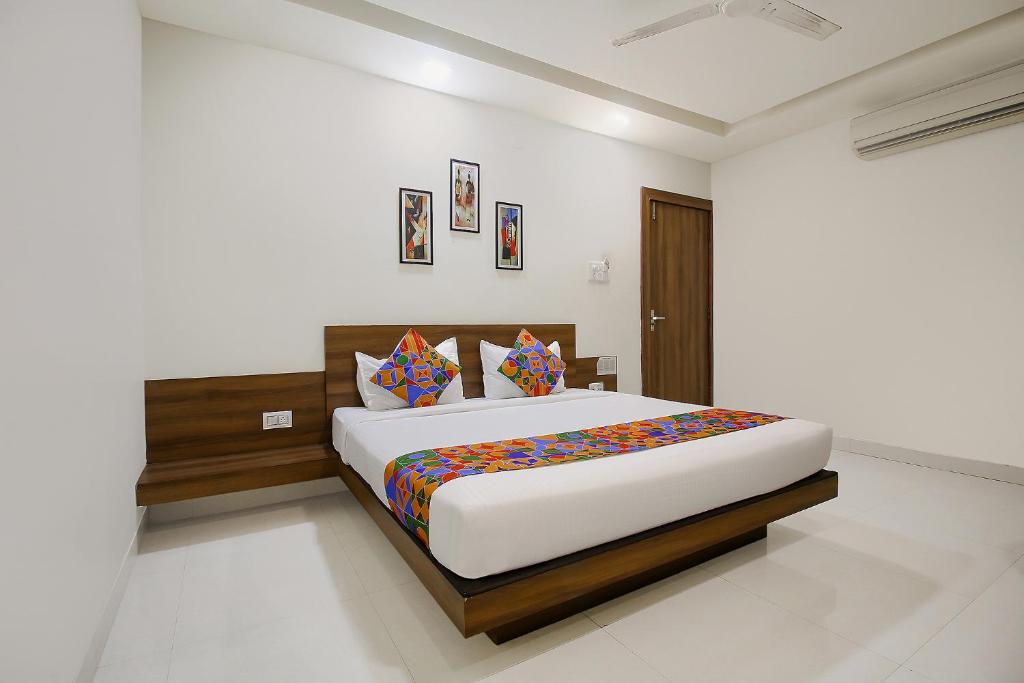 a bedroom with a large bed in a room at FabExpress Comfort Stay I in Bhopal