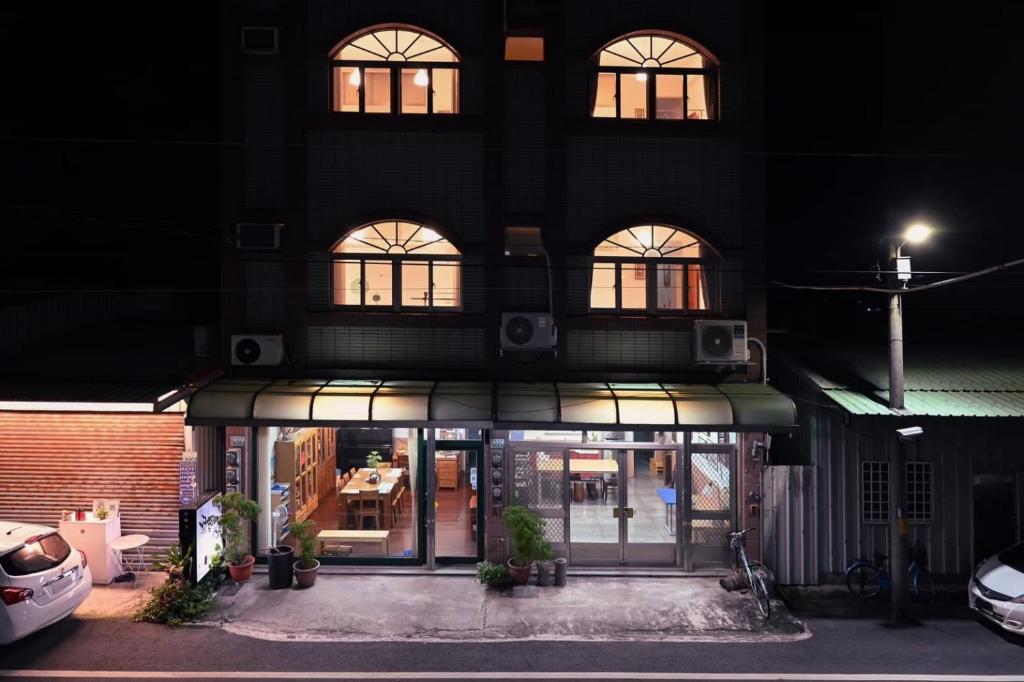 a building with a store front at night at Carlos Backpacker in Minxiong