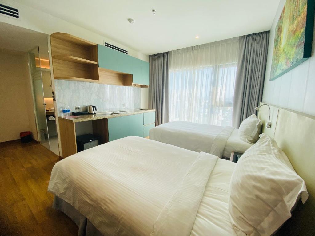 Postel nebo postele na pokoji v ubytování NAM Hotel & Residences