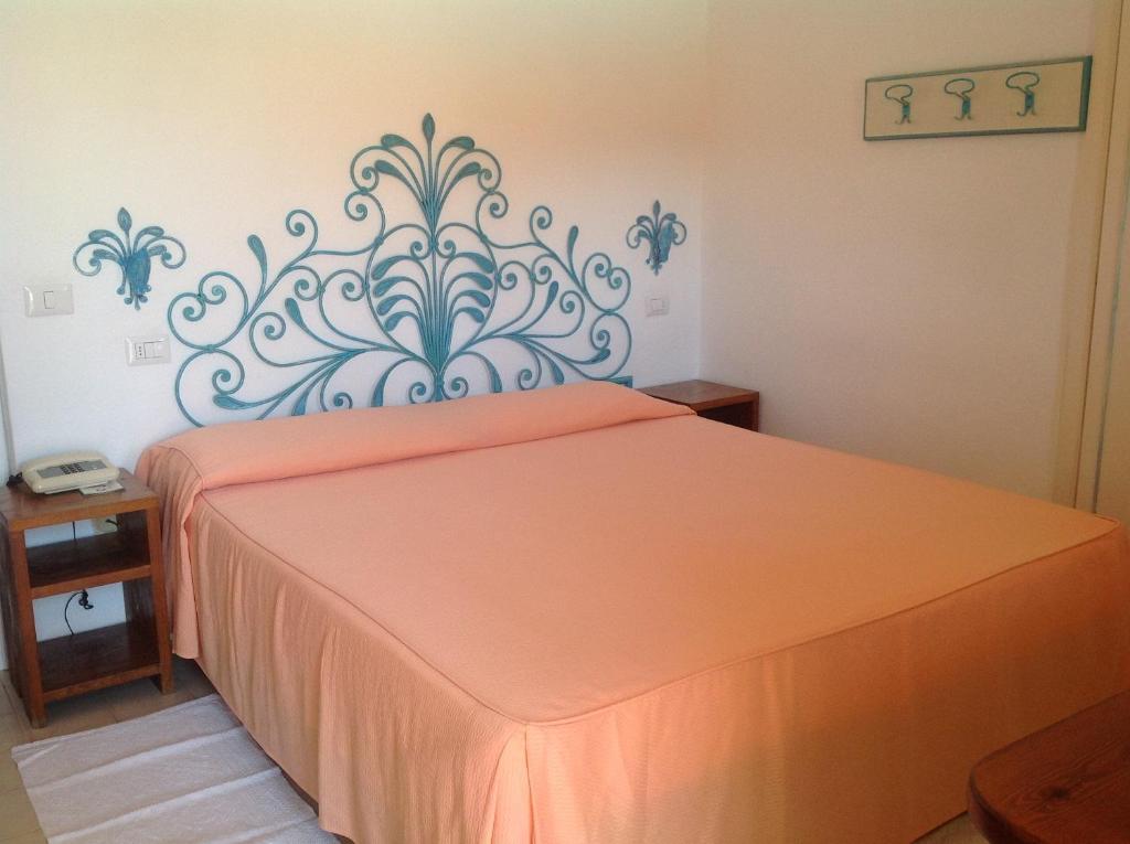 Postel nebo postele na pokoji v ubytování Hotel Villa Gemella