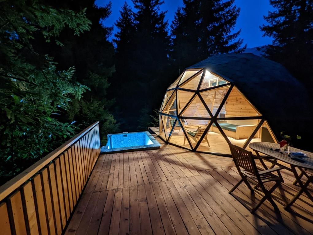 a yurt on a wooden deck at night at Seri in Keda
