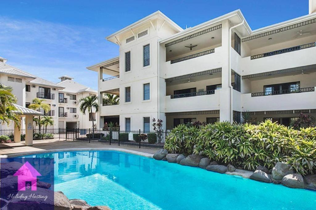 an apartment building with a swimming pool in front of it at Breakwater 13 in Townsville