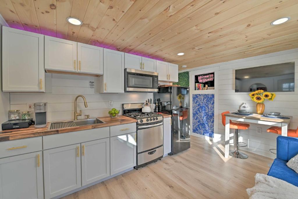 cocina con armarios blancos y techo de madera en Modern Apartment Near Hiking and Race Course en Saratoga Springs