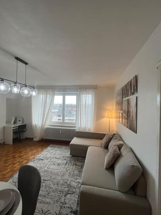 a living room with a couch and a table at Amajed in Namur