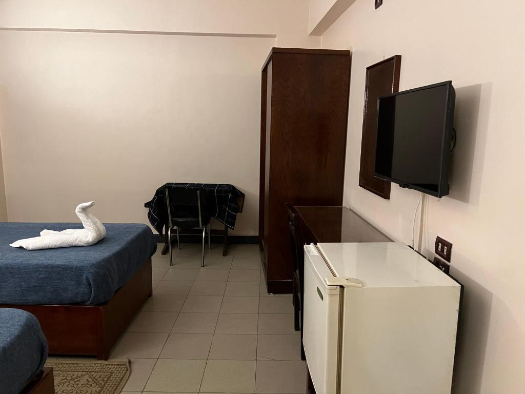 TV a/nebo společenská místnost v ubytování Anglo Hotel