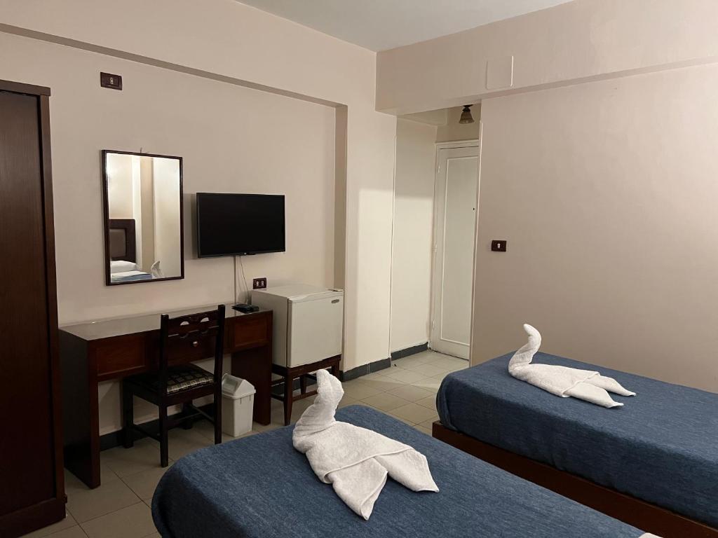 Postel nebo postele na pokoji v ubytování Anglo Hotel