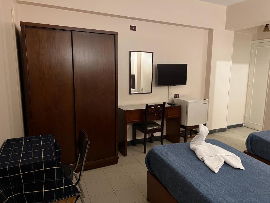 Postel nebo postele na pokoji v ubytování Anglo Hotel